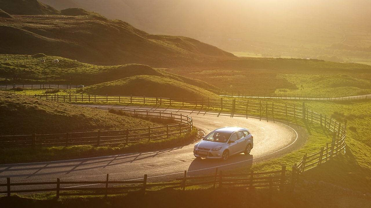 car driving in green field