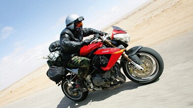 Gary Inman riding a motorbike through the dessert