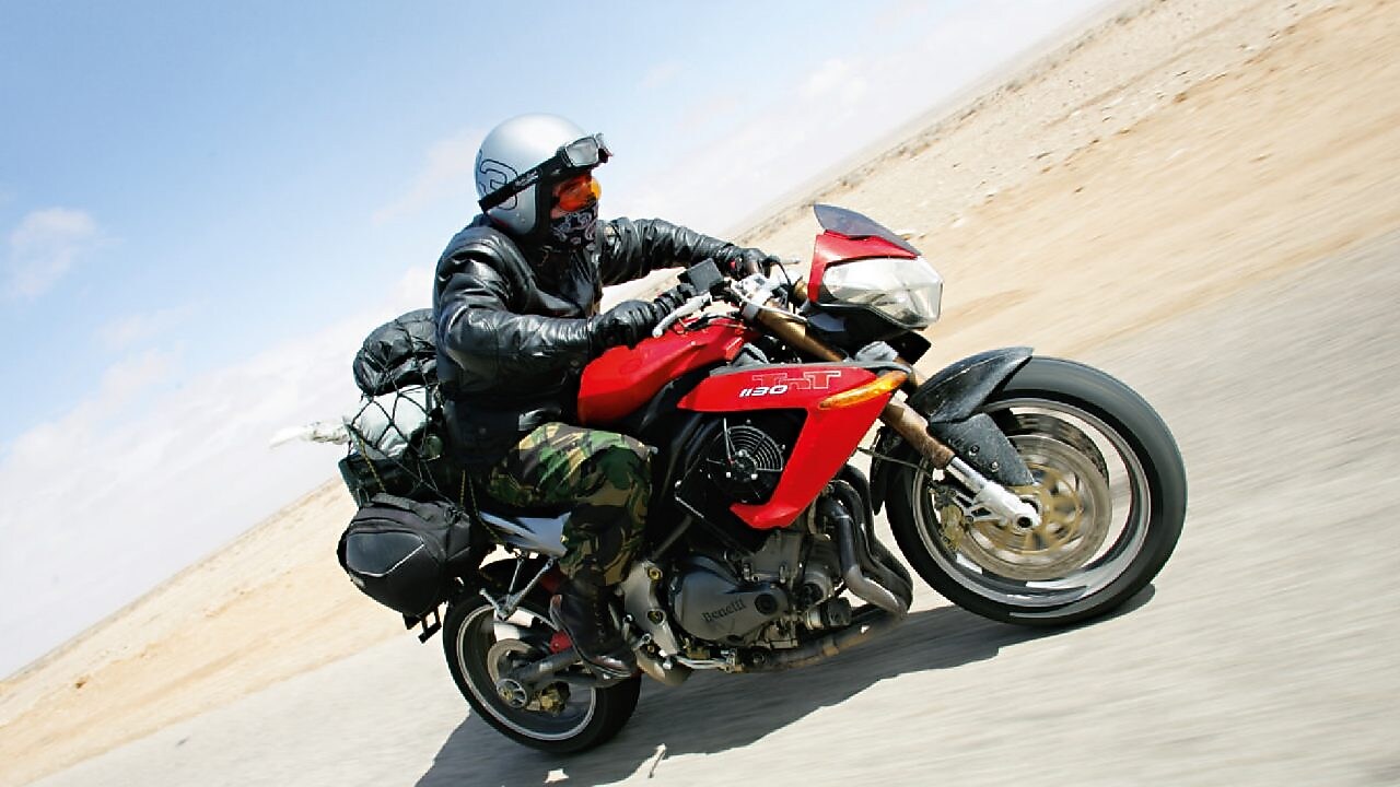 Gary Inman riding a motorbike through the dessert