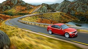 Red sedan driving on the road in Norway