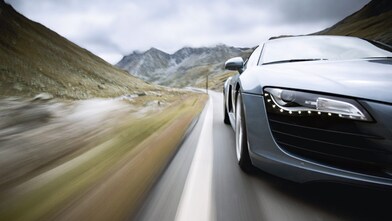car driving along a winding mountain road