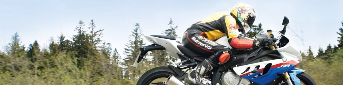 Man riding a motorbike along country road