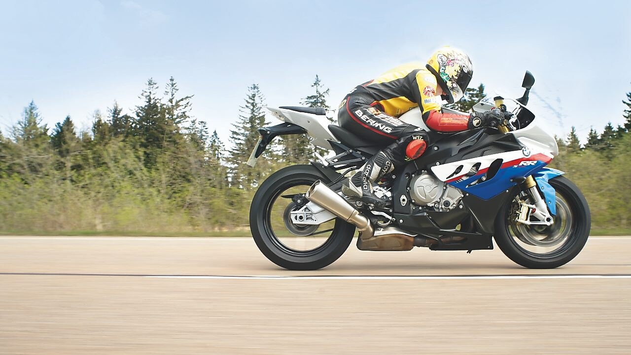 Man riding a motorbike along country road