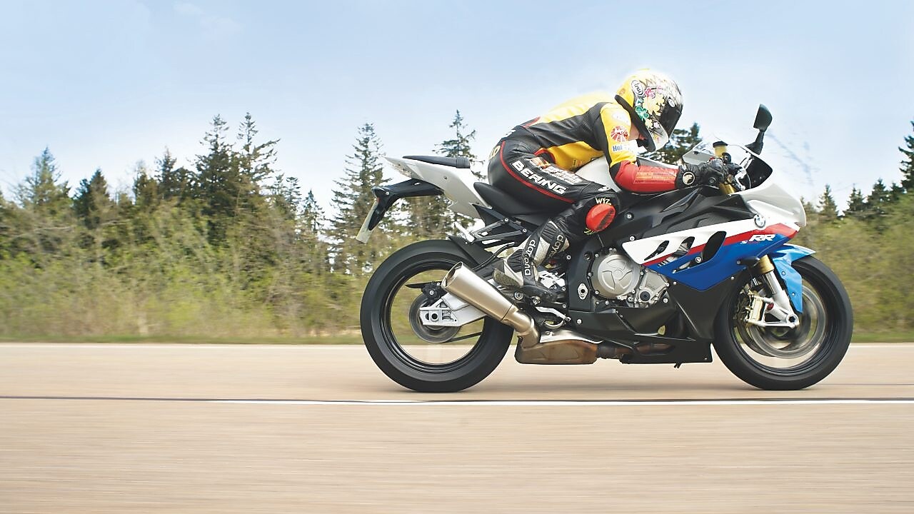 Man riding a motorbike along country road