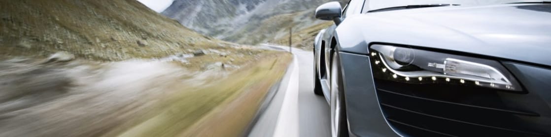 car driving along a winding mountain road