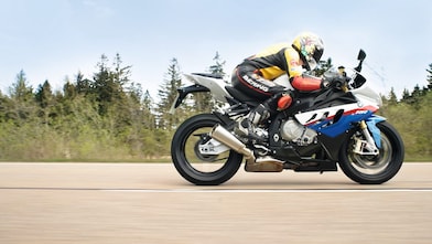 Man riding a motorbike along country road