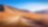 Empty dirt road surrounded by mountains