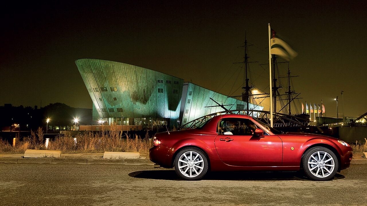 Red car parked on the streets of Amsterdam
