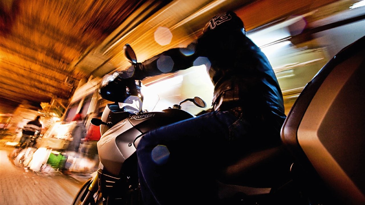 Man riding a bike in Marakesh at night