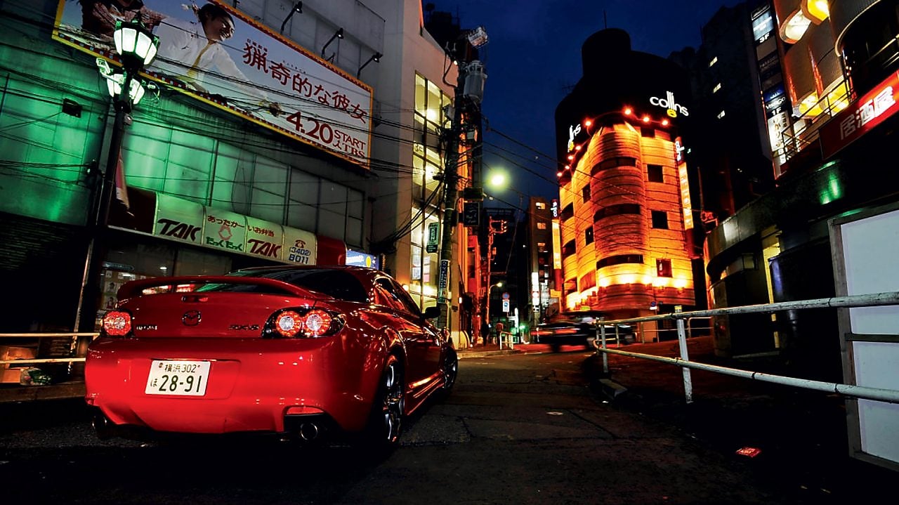 Mazda driving at night in Tokyo