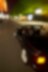 Black convertible car driving through Brugge streets at night