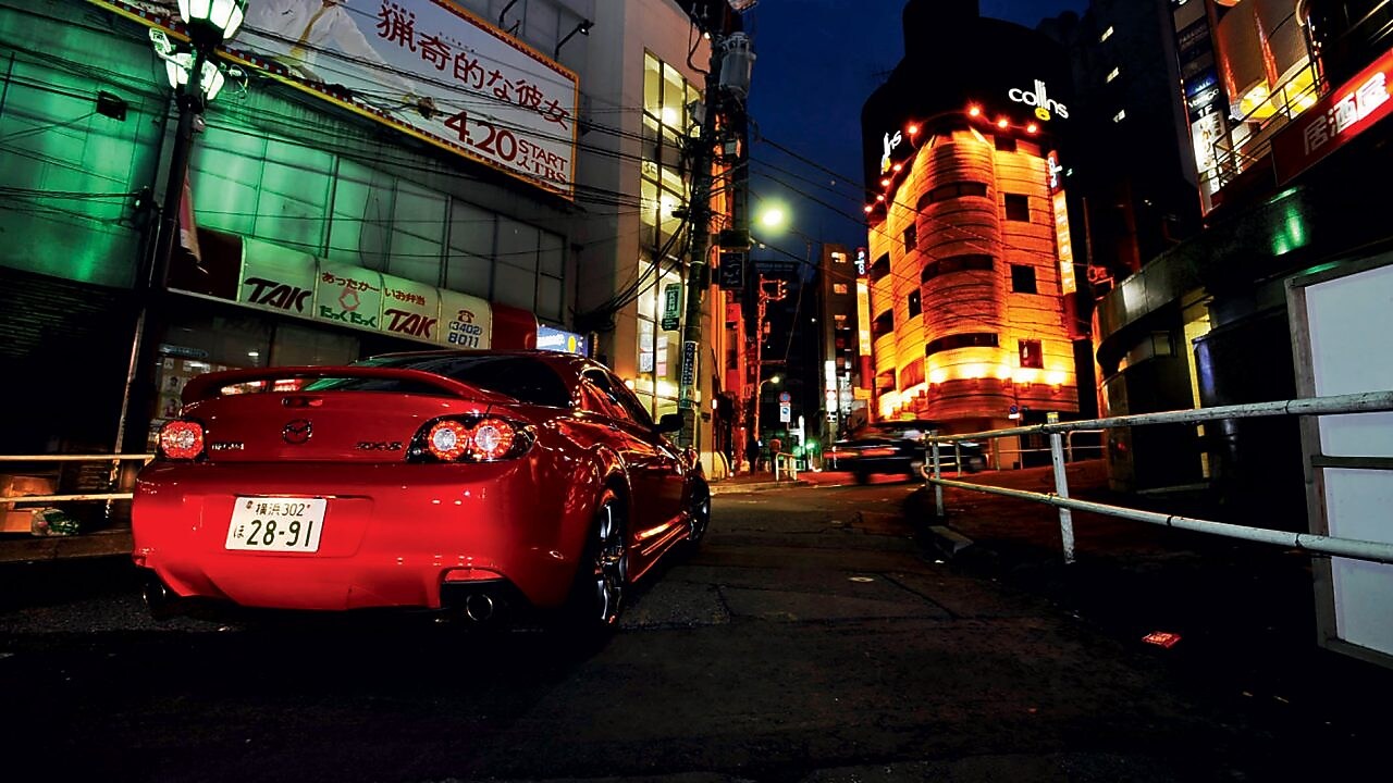 Mazda driving at night in Tokyo
