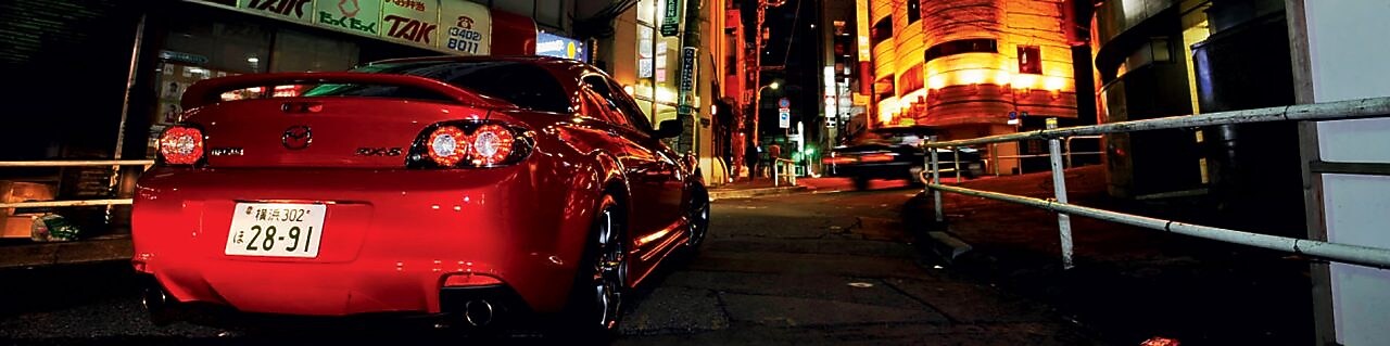 Mazda driving at night in Tokyo