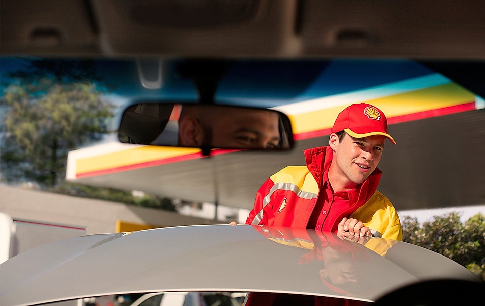 Shell assistant opening bonet of a car to check the oil