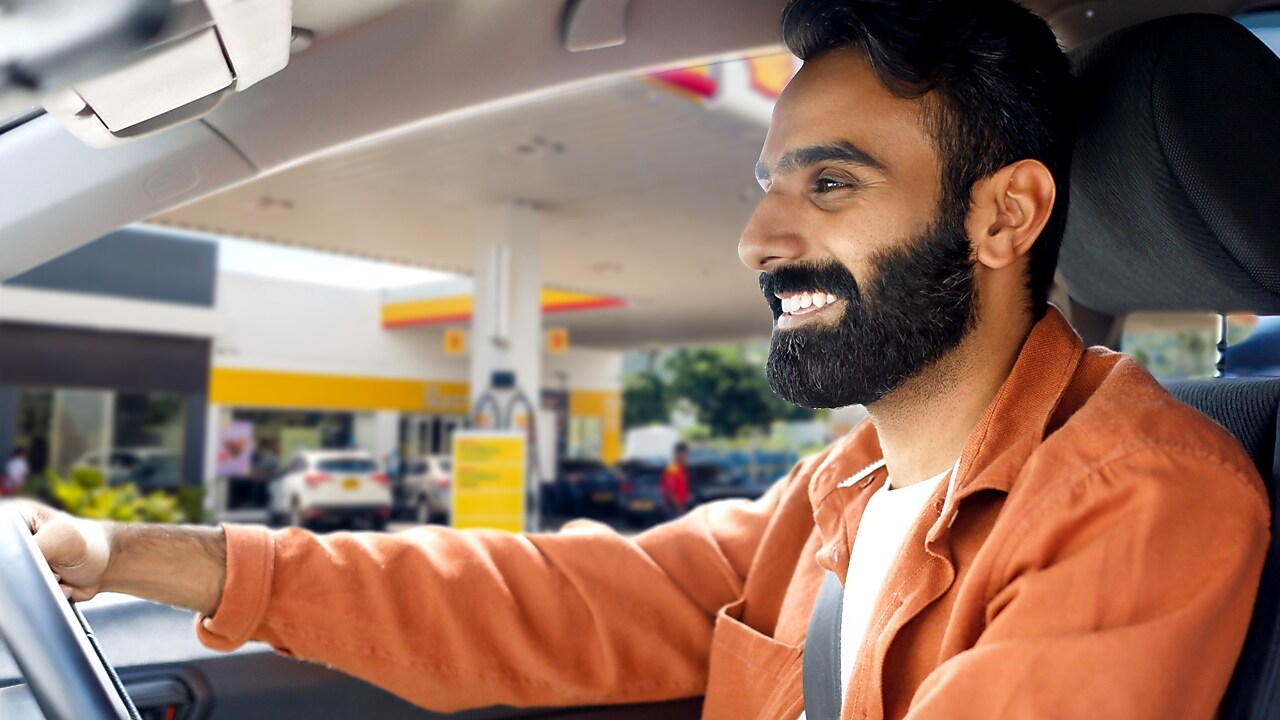 A person in a car on Shell station