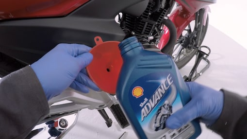hands holding shell advance new oil for motorcycle
