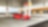 A red Ferrari sitting on a Shell station forecourt with a man leaning on a petrol pump