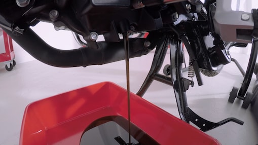 old engine oil being drained