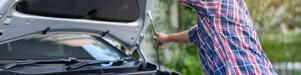 woman opening hood of car