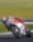 ducati superbike with rider cornering at speed on a racetrack