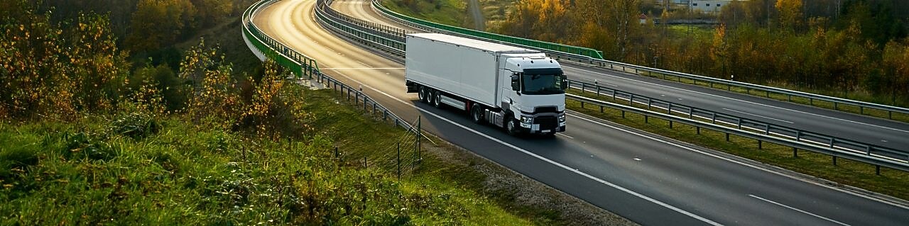 truck driving on empty road