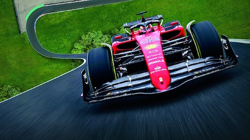 A red Scuderia Ferrari F1 car on a track with a distorted perspective to elongate the length of the track
