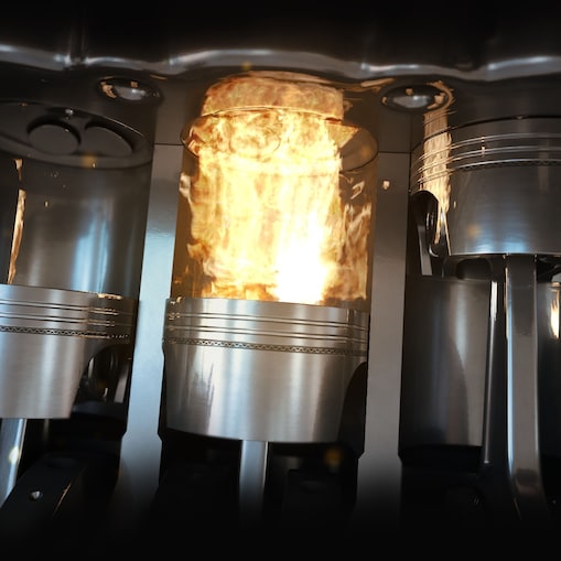 An up-close shot of car engine pistons firing